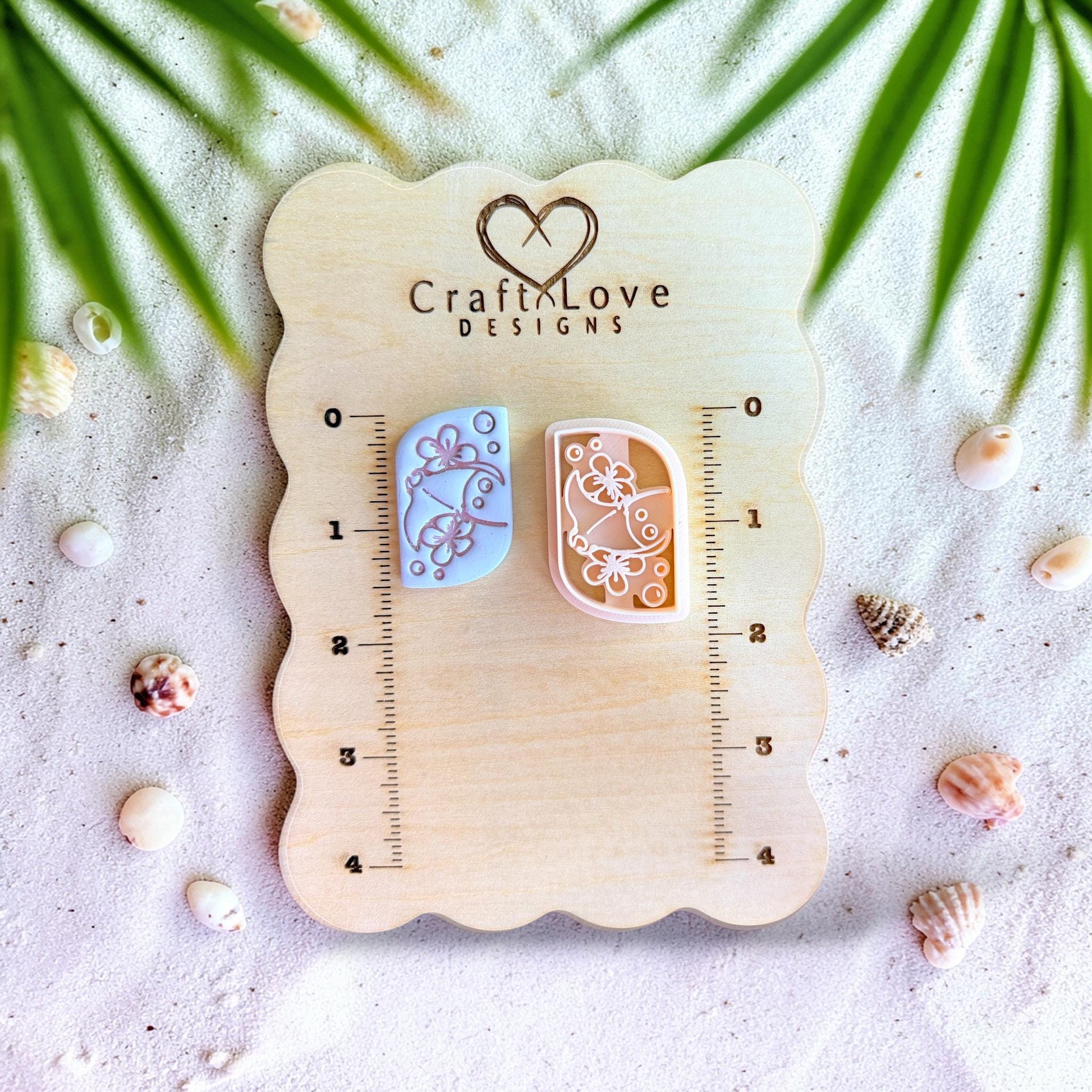 Polymer clay cutter displayed on measurement board showing scale for stingray earring design