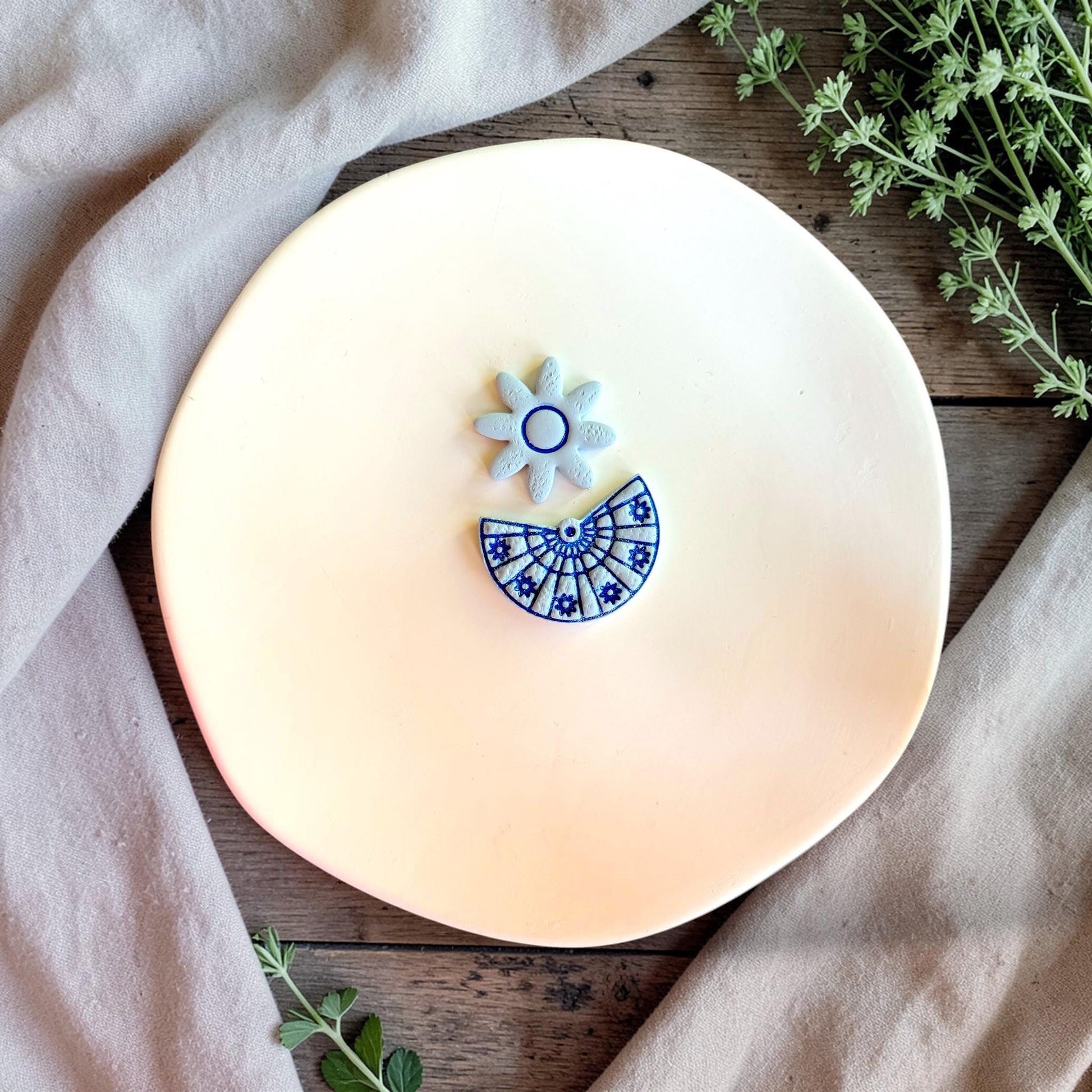 Daisy and fan polymer clay cutter set with floral mandala design on neutral background