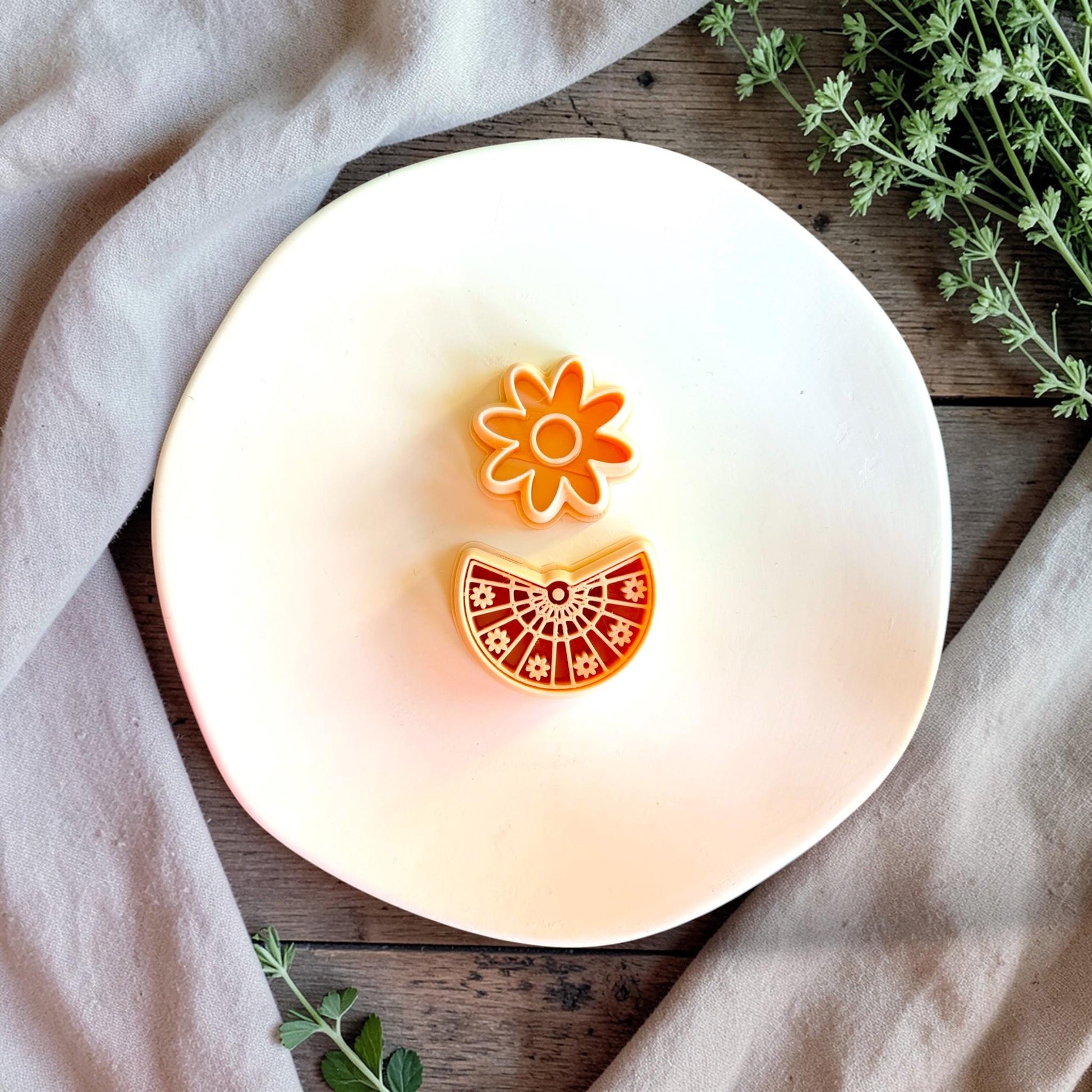 Close up of floral fan clay cutter with mandala detail and daisy top piece