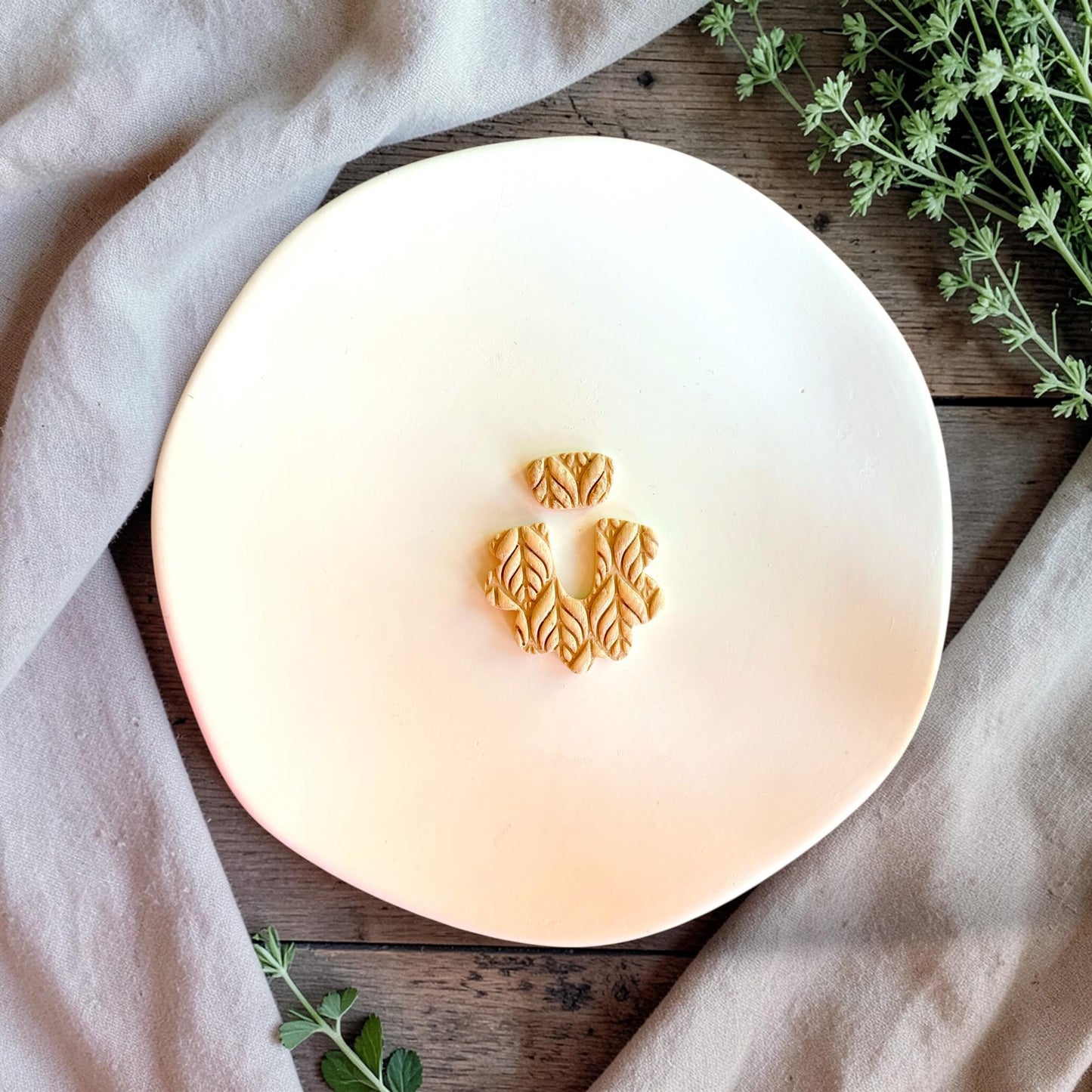 Leaf texture polymer clay cutter with organic botanical pattern on neutral styled background