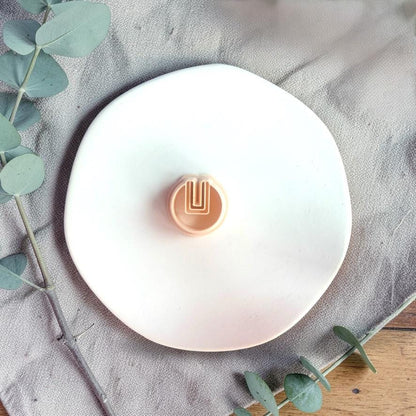Round U cutout clay cutter on white tray