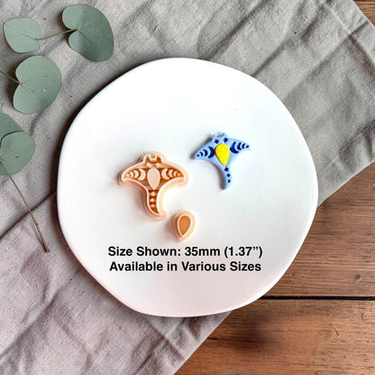 Polymer clay cutter and finished blue stingray piece shown together on a white plate with size text 35mm.