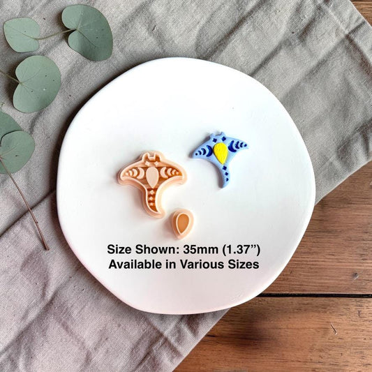 Polymer clay cutter and finished blue stingray piece shown together on a white plate with size text 35mm.