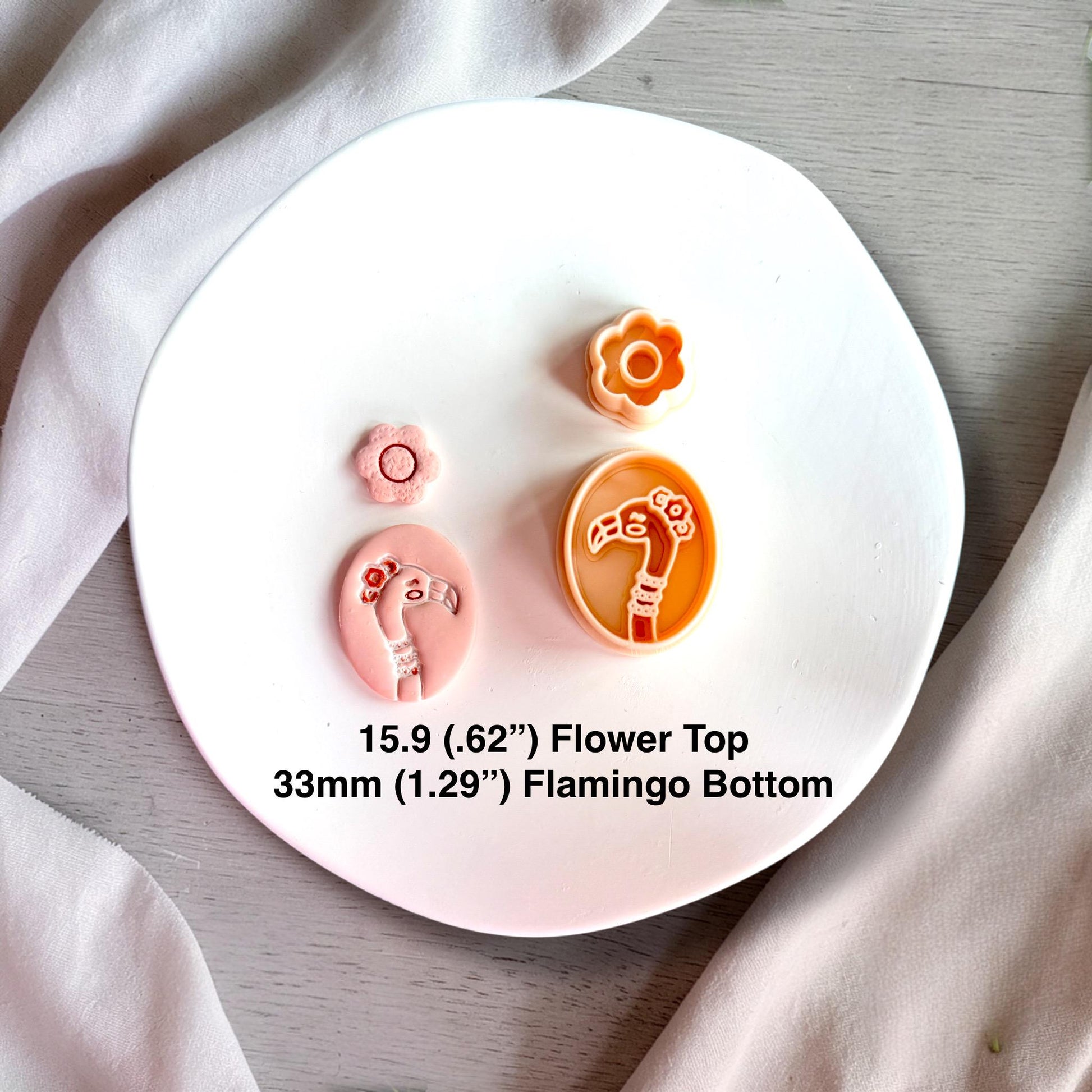 Polymer clay flamingo cutter set with flower topper and finished clay pieces showing size 33mm and 15.9mm.