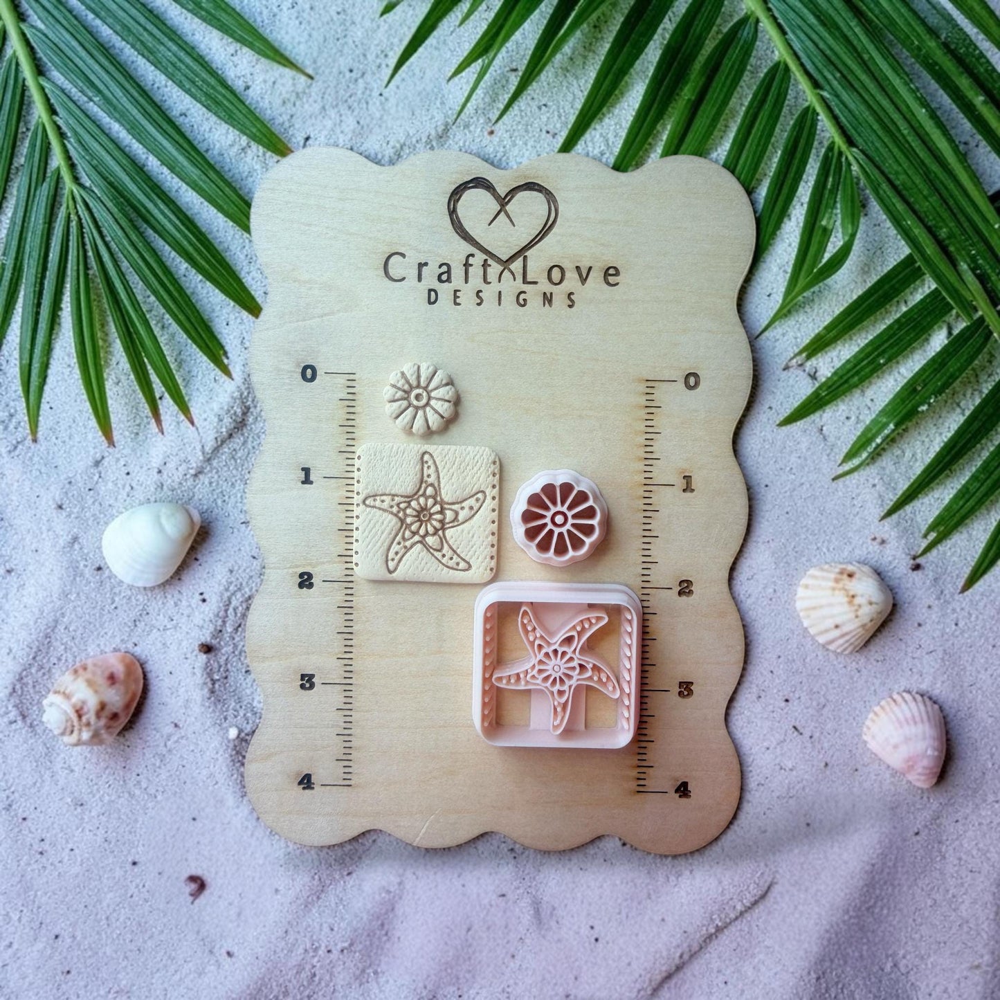 Polymer clay cutter set displayed on wooden measurement board with coastal styled background