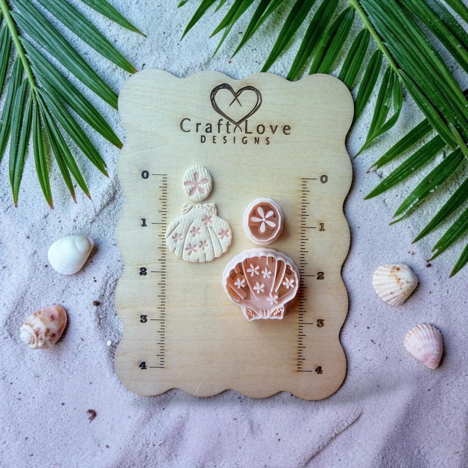 Polymer clay cutter displayed on wooden board with coastal styled background