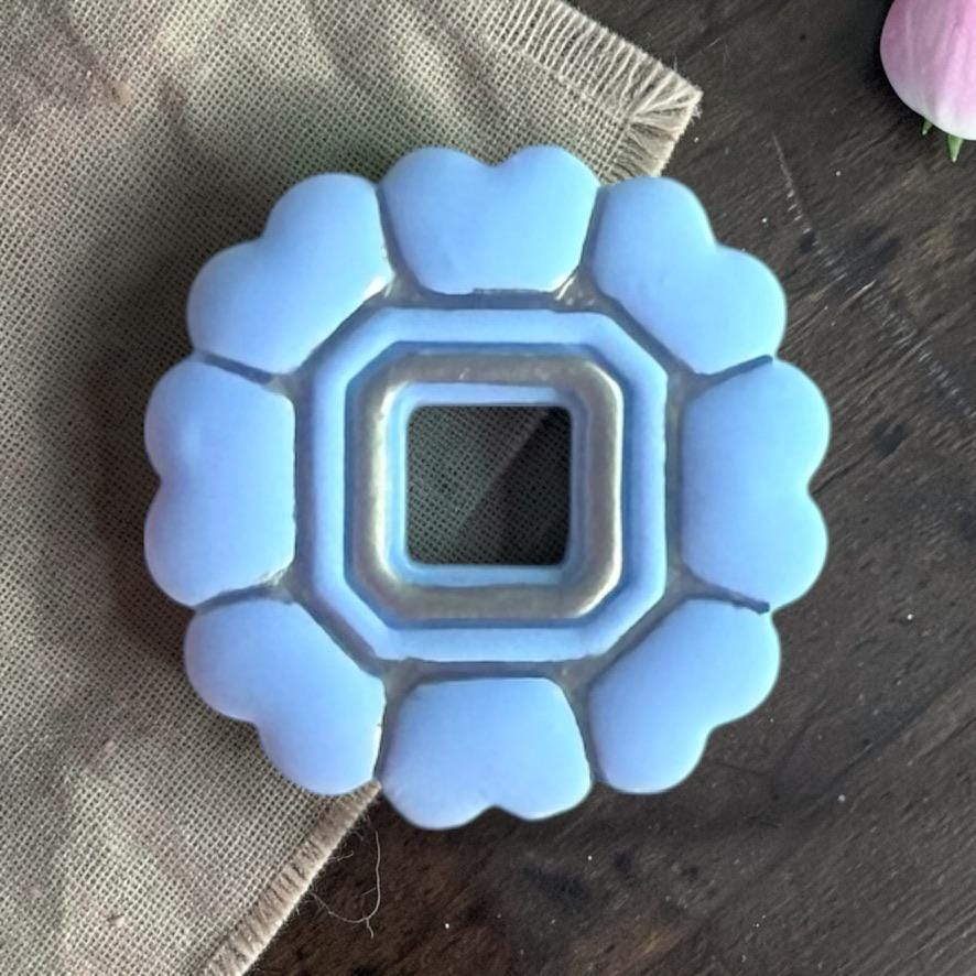 Finished clay piece showing scalloped heart shape with hollow center design