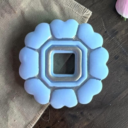 Finished clay piece showing scalloped heart shape with hollow center design