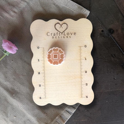 Heart cutter displayed on wooden sizing board with measurement grid
