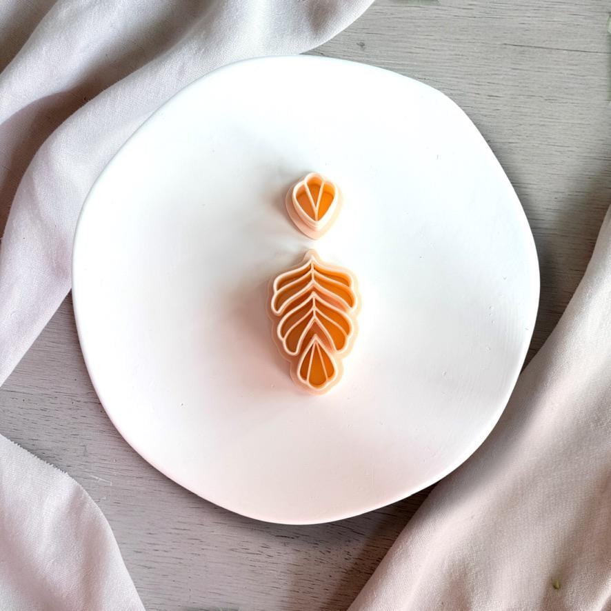 Fern leaf polymer clay cutter with matching imprint and layered design shown