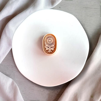 Floral oval cutter with detailed imprint shown on white background