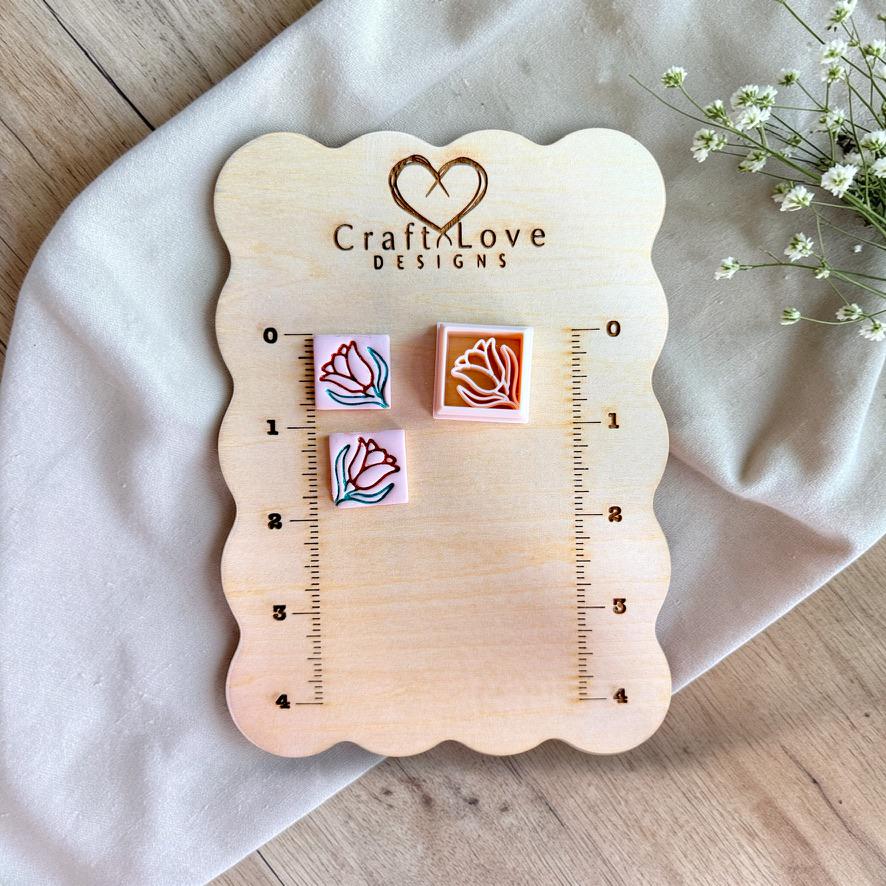 Mini floral square polymer clay cutter shown on measurement board for size reference