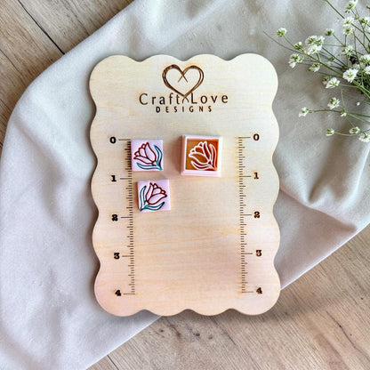 Mini floral square polymer clay cutter shown on measurement board for size reference