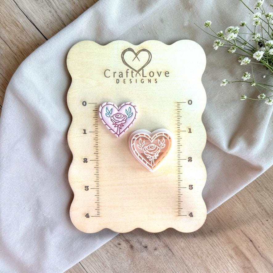 Rose heart polymer clay cutter displayed on measurement board for size reference