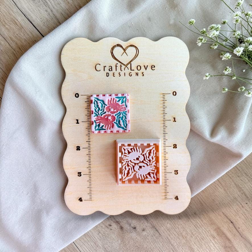 Crab polymer clay cutter displayed on wooden sizing board