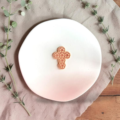 Floral cross clay closeup on white display plate