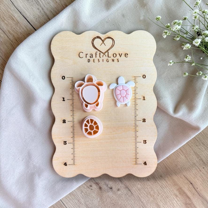 Sea turtle polymer clay cutter set displayed on wooden size board with ruler markings