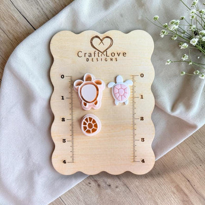 Sea turtle polymer clay cutter set displayed on wooden size board with ruler markings