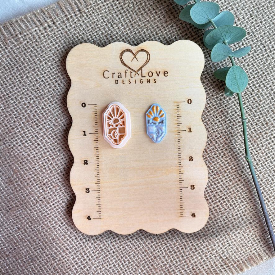 Sky and moon stained glass polymer clay cutter and sample on wooden measurement board