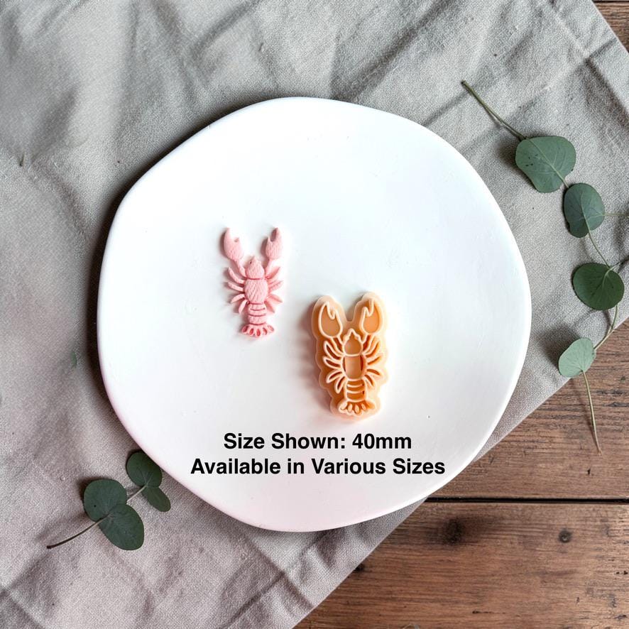 Lobster clay piece with cutter showing 40mm size reference on white plate