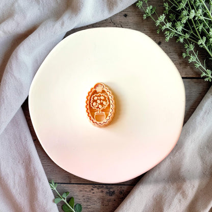 Lemon tree polymer clay cutter with scalloped frame on neutral background