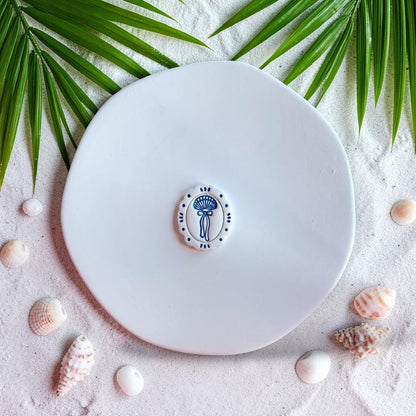 Finished seashell bow earring in blue and white with delicate ribbon detail