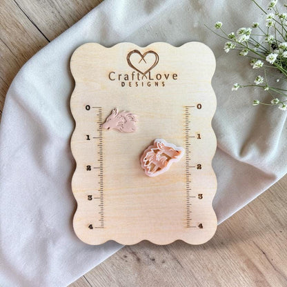 Wolf cutter and finished piece displayed on wooden measurement board