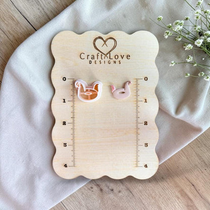 Chicken floatie cutter and finished clay piece displayed on wooden ruler board