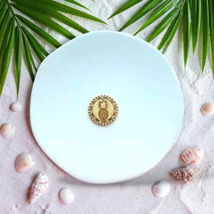 Finished clay earring with pineapple design inside circular frame