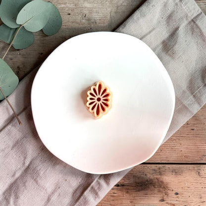 Daisy flower polymer clay cutter displayed on neutral background with eucalyptus leaves