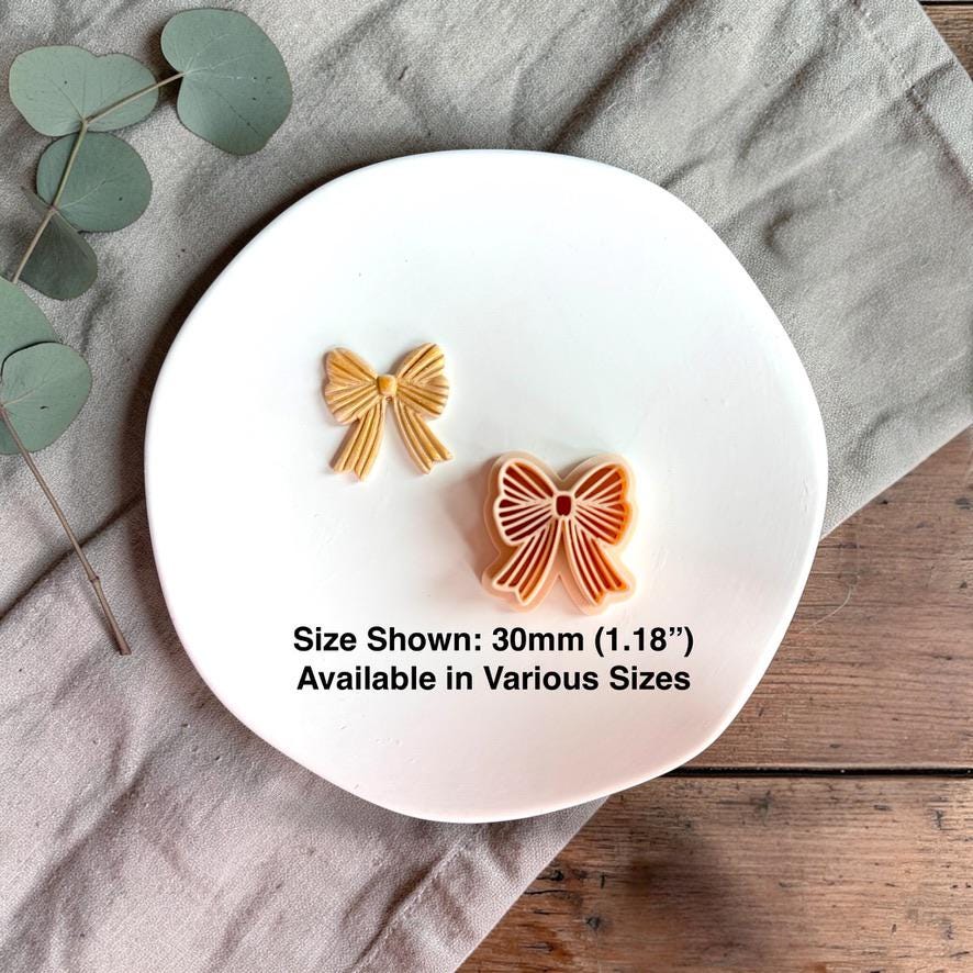 Bow clay cutter and finished piece with 30mm size reference on white plate
