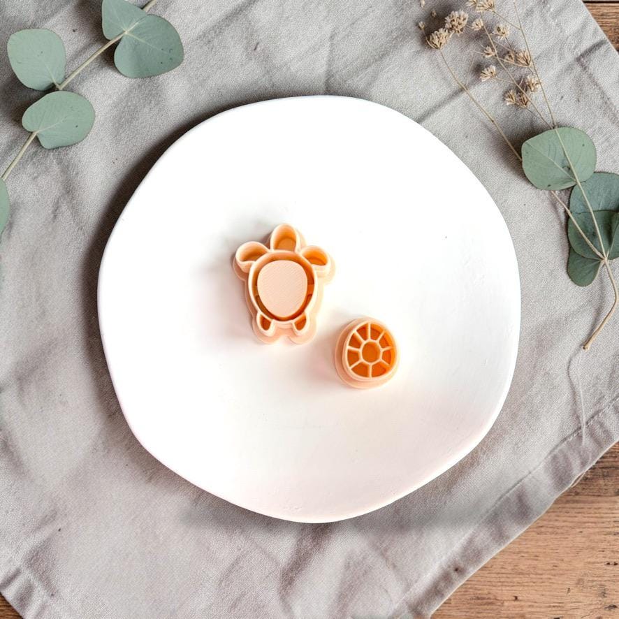 Sea turtle polymer clay cutter with shell detail stamp on white plate