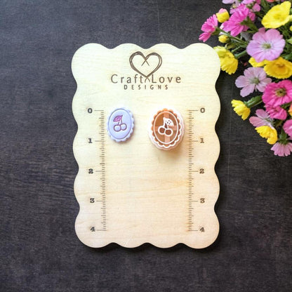 Cherry cameo polymer clay cutter on wooden size board