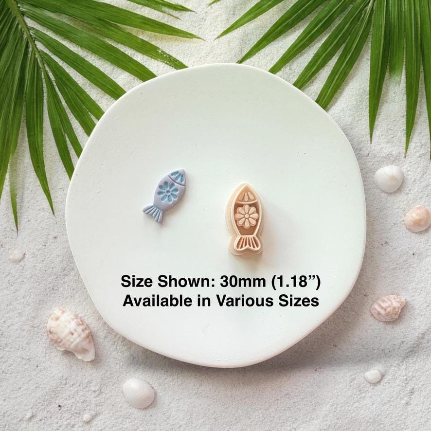 Fish cutter and finished clay pieces with size text 30mm on white plate coastal background
