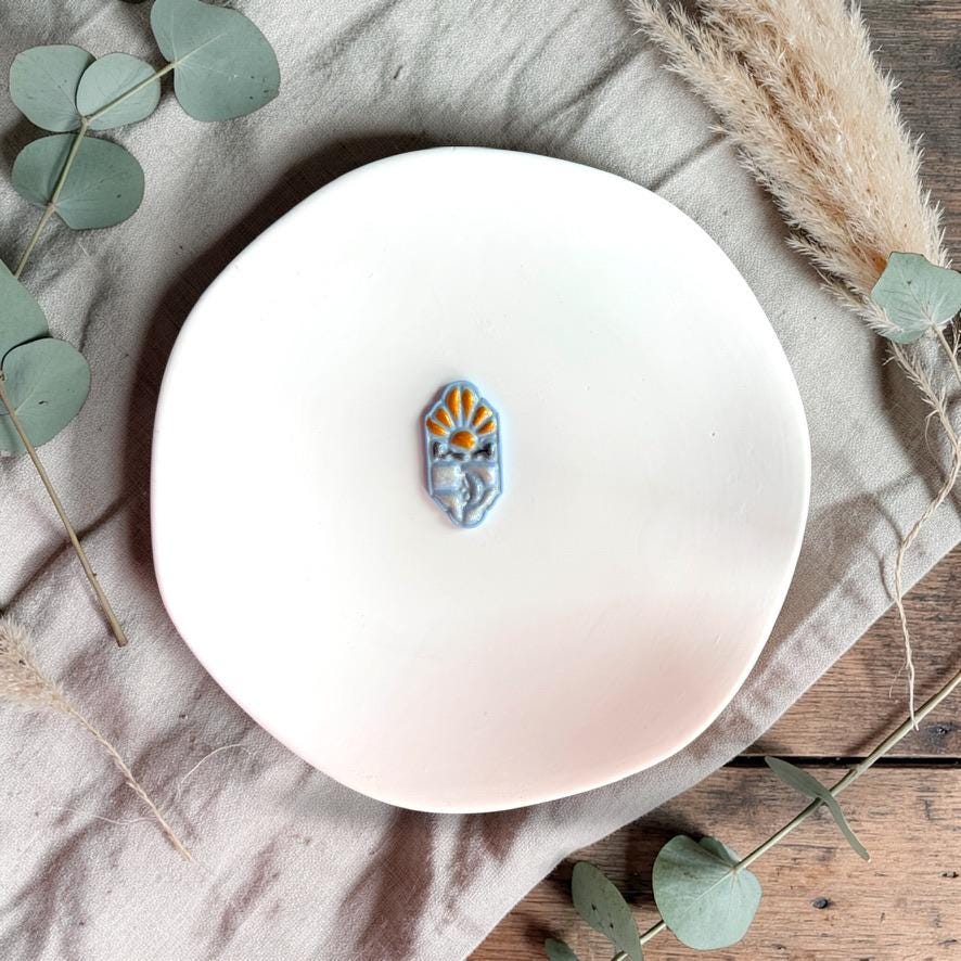 Blue sky and moon clay sample on white plate with greenery and soft decor