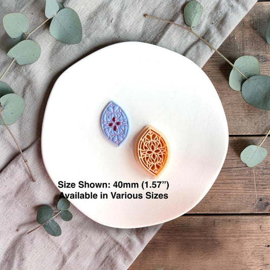 Teardrop clay pieces with cutter showing 40mm size reference on white plate