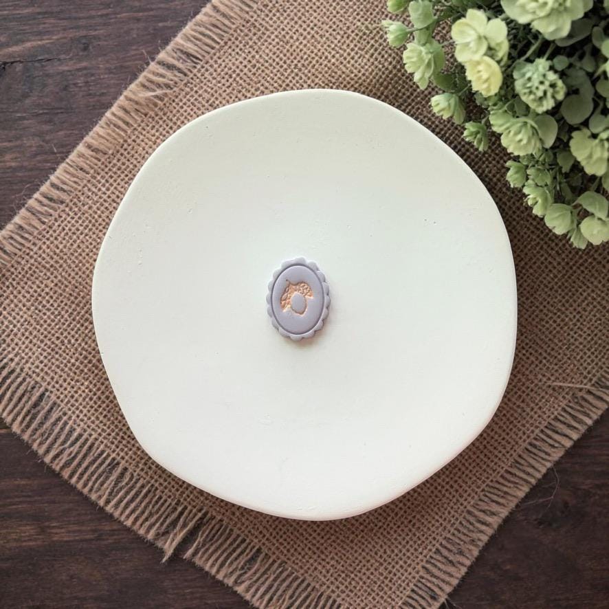 lemon cameo cutter with scalloped frame on white plate