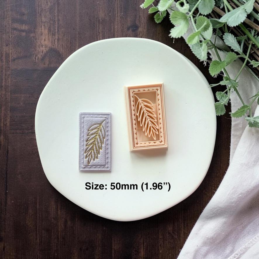 leaf cutter and finished clay piece shown together with size text on white plate