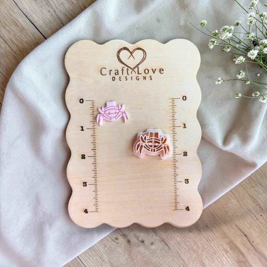 Crab cutter and finished piece displayed on wooden measurement board