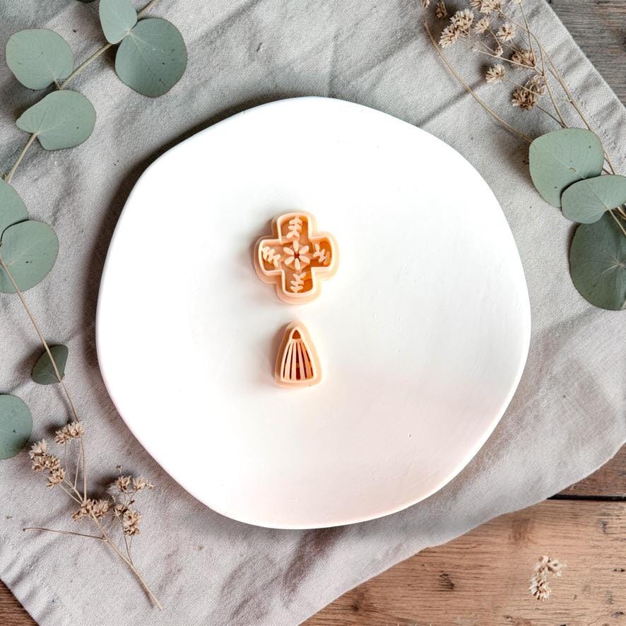 Ceramic tile style polymer clay cutter with matching drop piece on white plate