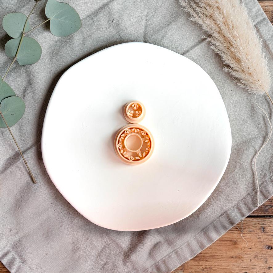 Floral ring polymer clay cutter with open pattern design displayed on white background