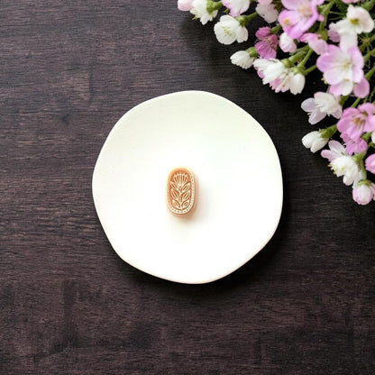 Oval botanical clay cutter on white background with flower detail