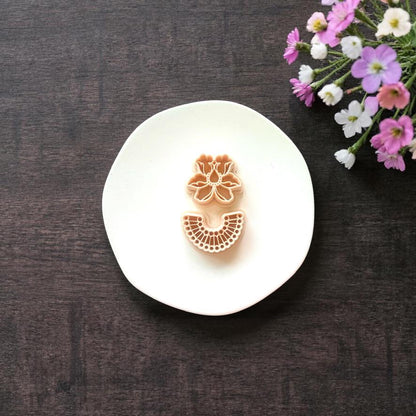 Floral top and arch base cutter shown together on white surface