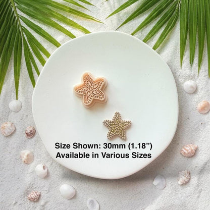 Starfish clay pieces with size text 30mm displayed on white plate with seashells and sand