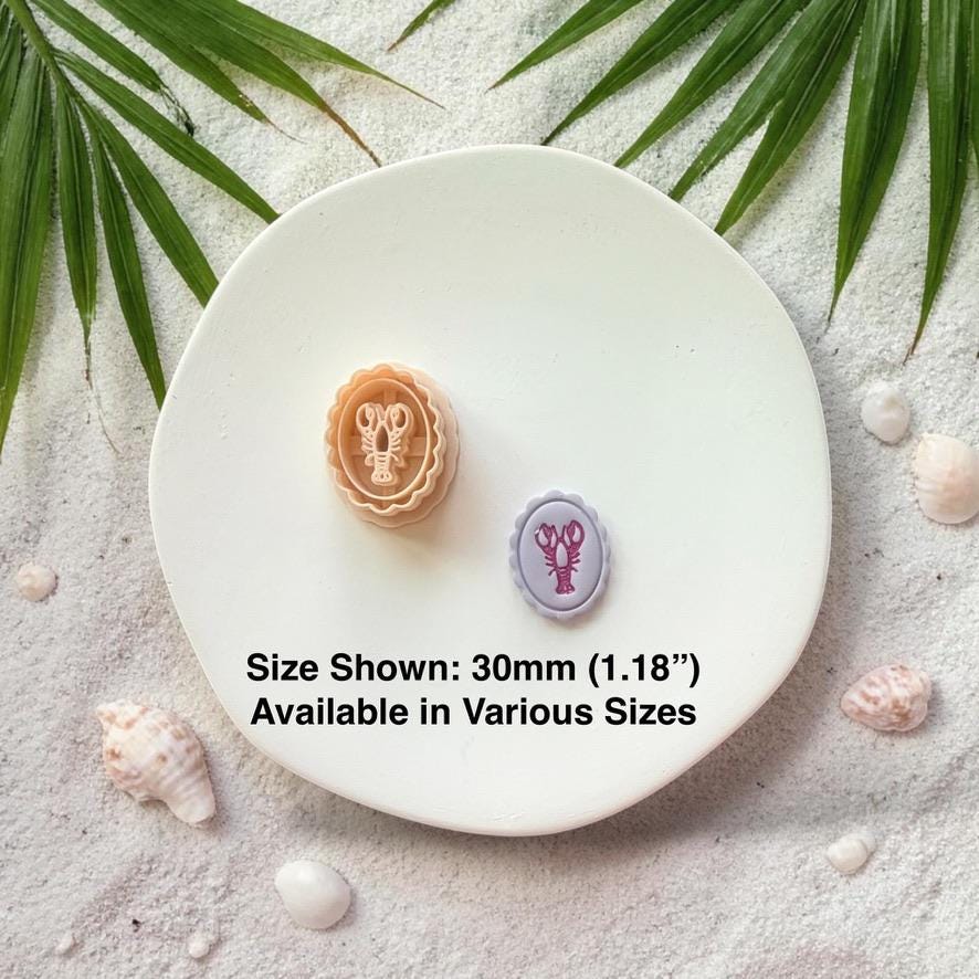 Lobster cameo cutter and finished clay piece with size text 30mm on white plate beach background