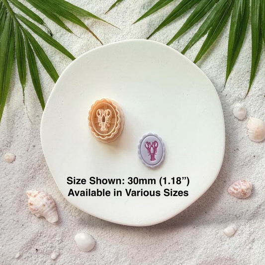 Lobster cameo cutter and finished clay piece with size text 30mm on white plate beach background