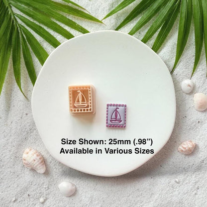 Sailboat cutter and finished clay pieces with size text 25mm on white plate beach background