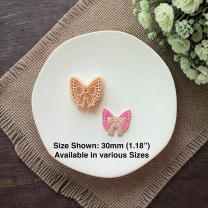 butterfly bow clay cutter with finished earring showing size comparison