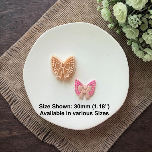 butterfly bow clay cutter with finished earring showing size comparison