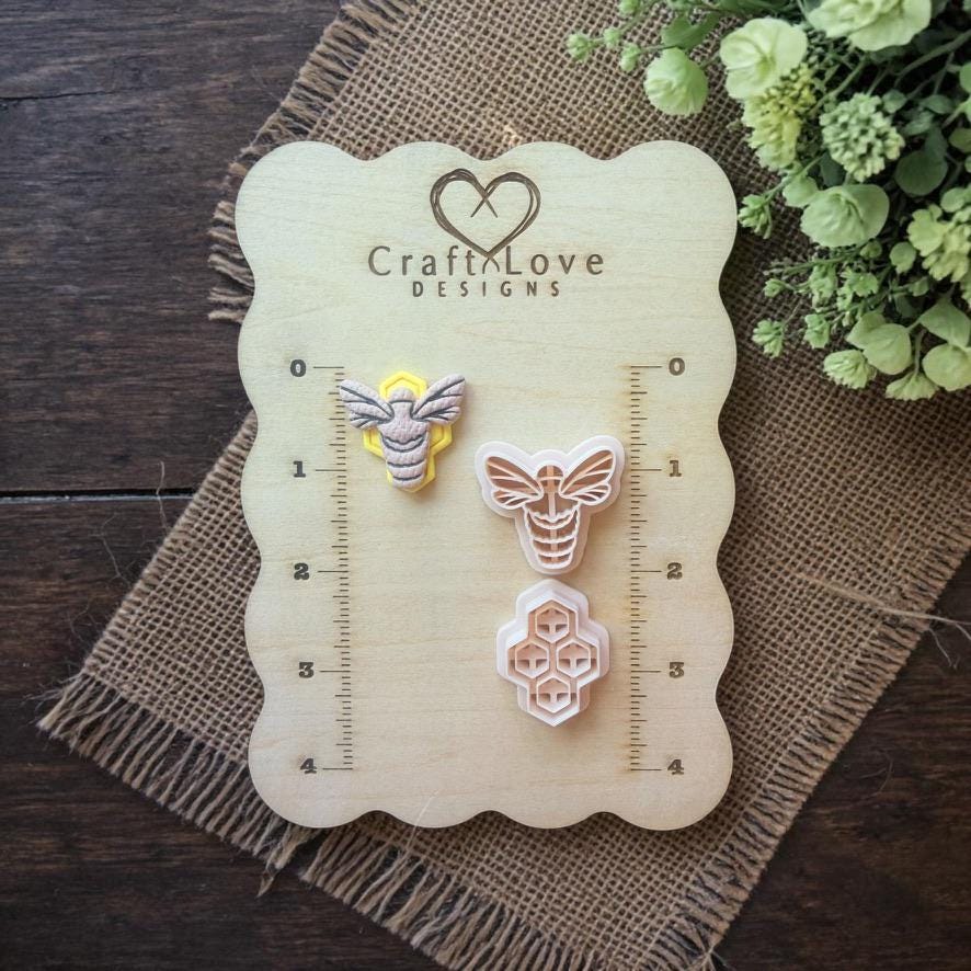 bee and honeycomb cutters displayed on wooden ruler board